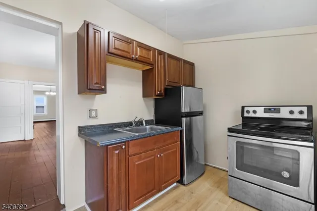 a kitchen with a stove and a refrigerator