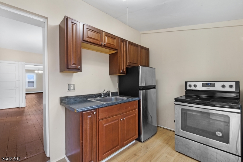 21 Short Street Trenton, NJ 08618 - Photo 19 of 22 a kitchen with a stove and a refrigerator
