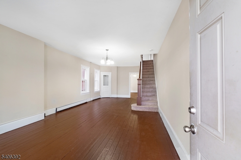 21 Short Street Trenton, NJ 08618 - Photo 3 of 22 an empty room with wooden floor and entryway