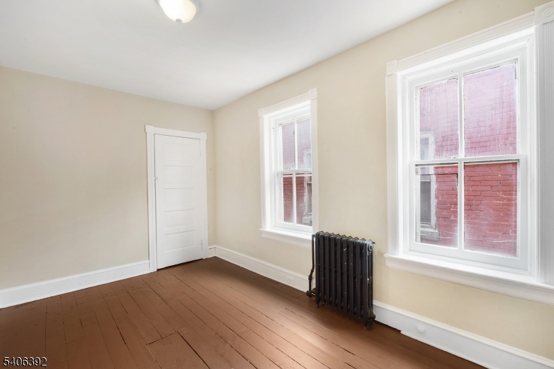 21 Short Street Trenton, NJ 08618 - Photo 10 of 22 an empty room with wooden floor and windows