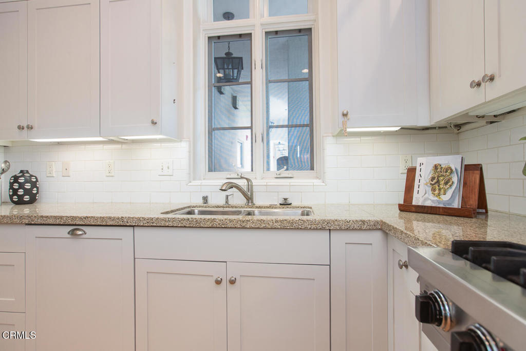 700 Union Street, Unit 302 Pasadena, CA 91101 - Photo 14 of 30 a kitchen with granite countertop white cabinets and sink