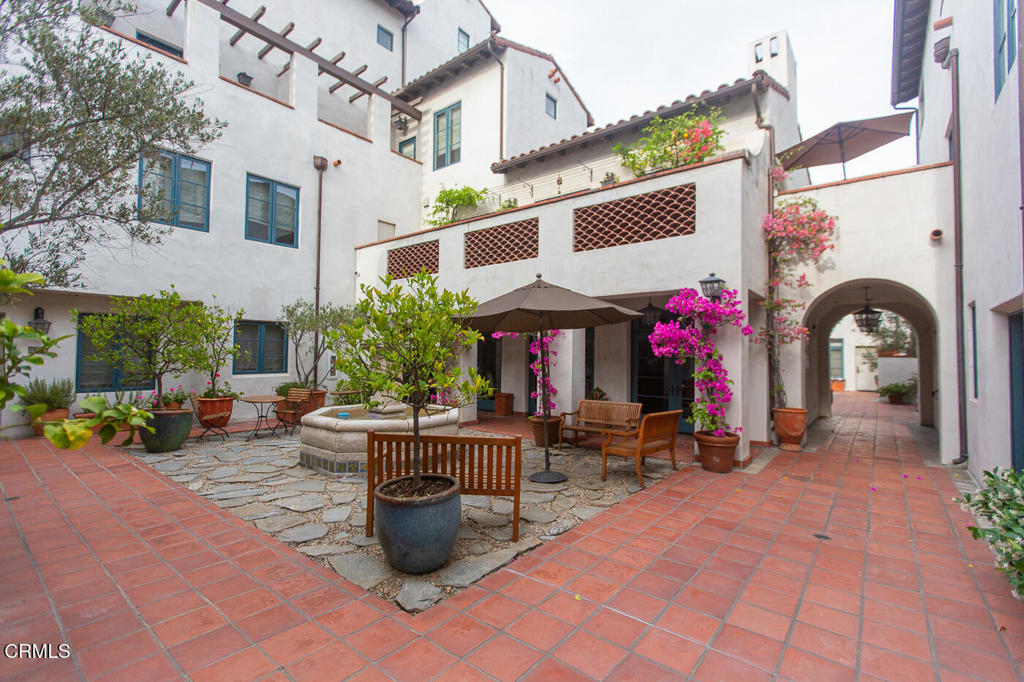 700 Union Street, Unit 302 Pasadena, CA 91101 - Photo 29 of 30 a view of the patio with dining table and chairs under an umbrella