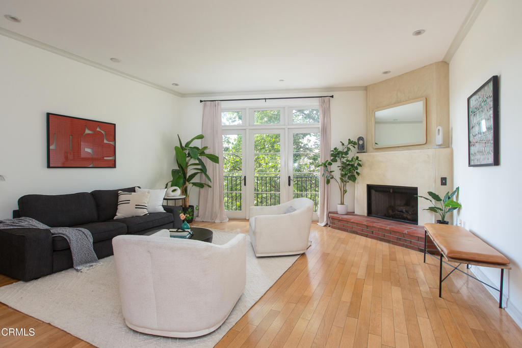 700 Union Street, Unit 302 Pasadena, CA 91101 - Photo 5 of 30 a living room with furniture a large window and a fireplace