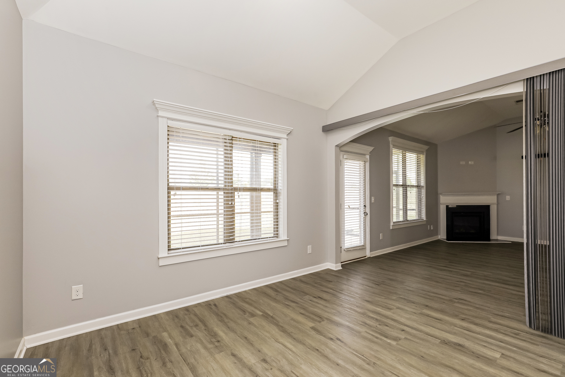 3216 Alhambra Circle Hampton, GA 30228 - Photo 5 of 21 an empty room with wooden floor and windows