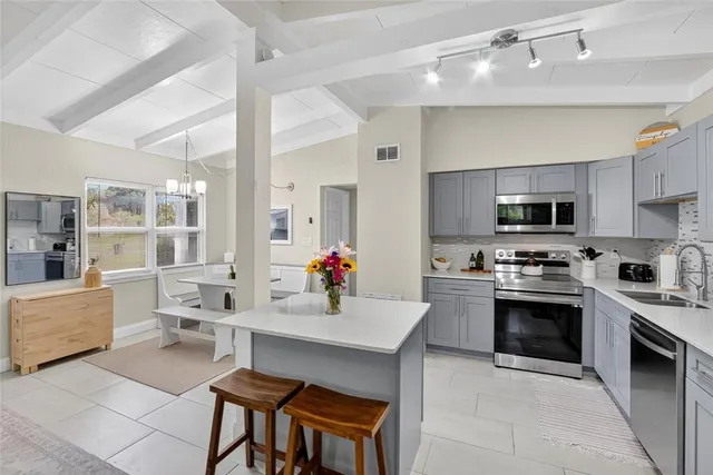 a kitchen with a sink stove and microwave
