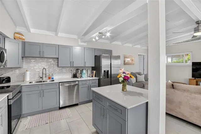 a kitchen with a sink cabinets and window