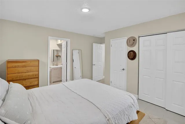 a bedroom with a bed and a closet