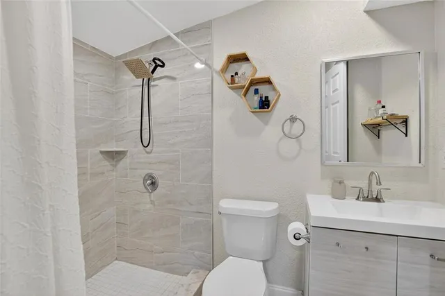 a bathroom with a toilet sink and shower
