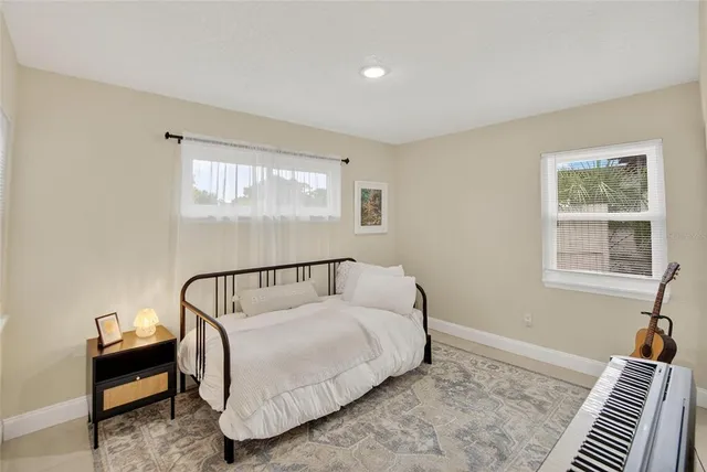 a bedroom with a bed and a window