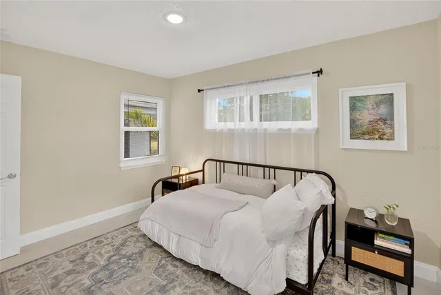 a bedroom with a bed and a window