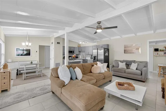 a living room with furniture and view of kitchen