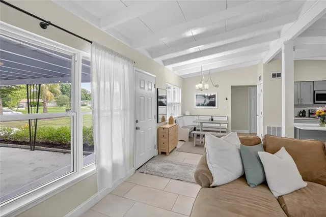 a living room with furniture and large windows