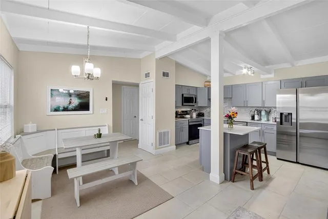 a living room with furniture a dining table and kitchen view