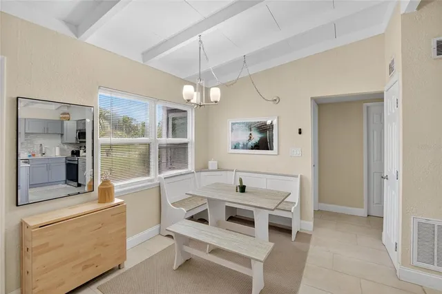 a view of kitchen with sink and refrigerator