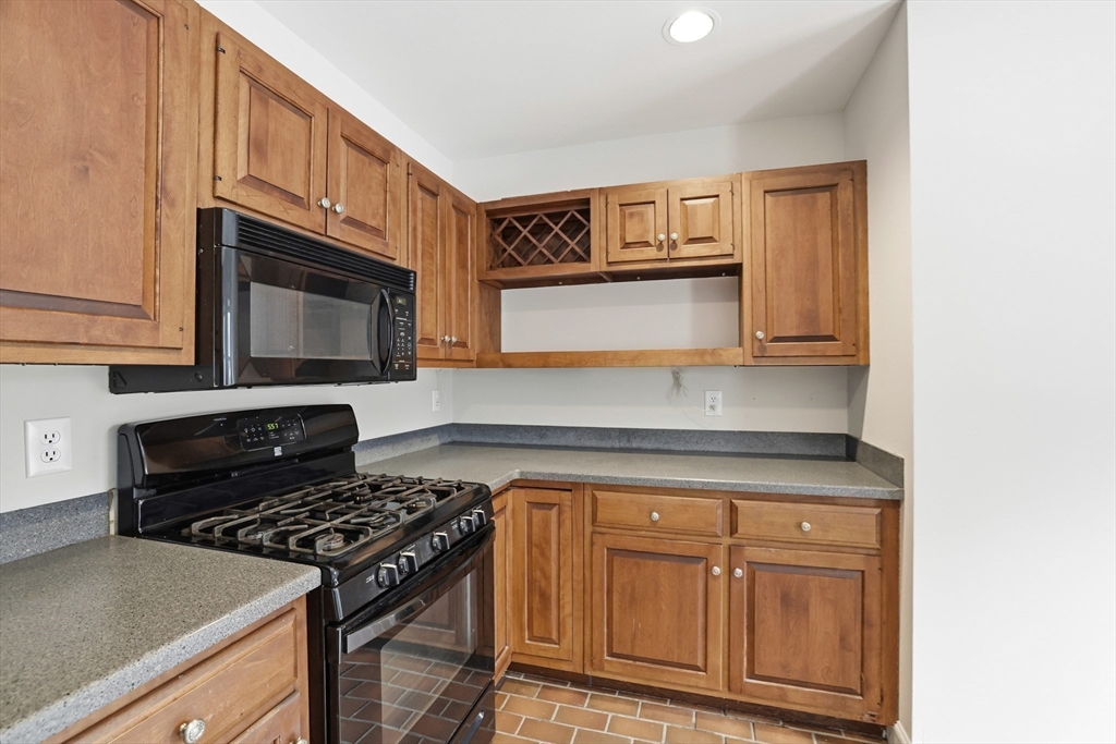 74 Branch Street, Unit 15 Scituate, MA 02066 - Photo 11 of 26 a kitchen with granite countertop cabinets and steel appliances
