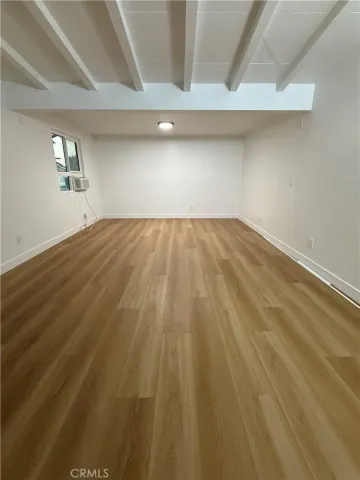 a kitchen with a sink and wooden floor