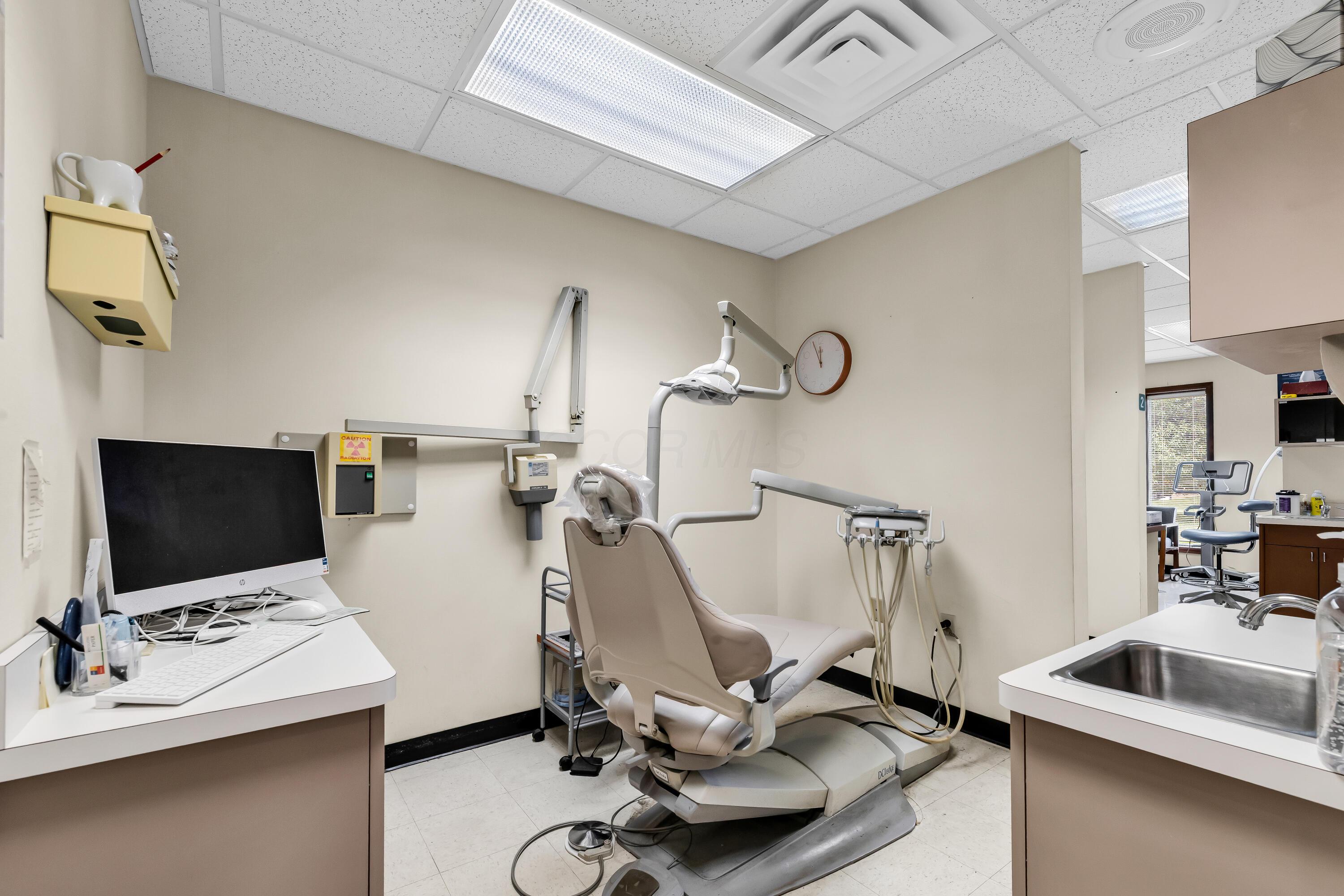 1240 Crescent Heights Road Marion, OH 43302 - Photo 45 of 60 • Neutral vinyl flooring • Ivory painted walls • Acoustic ceiling tiles • Fluorescent lighting • Vanity with single bowl, stainless steel sinktop