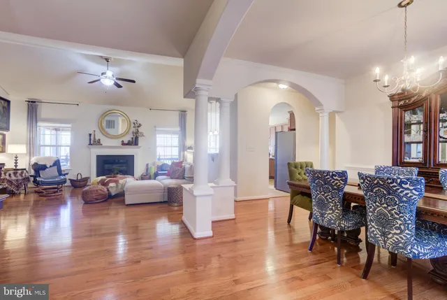 a living room with furniture a fireplace and a large window