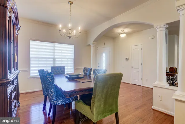 a view of a kitchen with kitchen island a sink wooden floor and counter top space