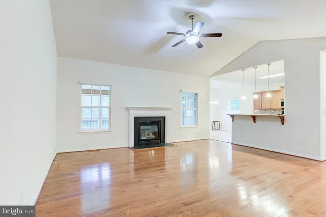 a kitchen with stainless steel appliances granite countertop a stove top oven a sink dishwasher a refrigerator and a microwave