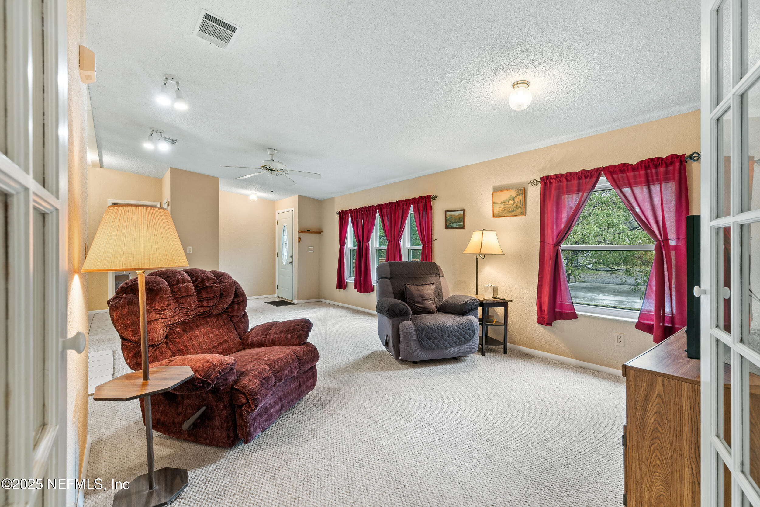 5671 Chugah Street Keystone Heights, FL 32656 - Photo 11 of 47 a living room with furniture and a flat screen tv