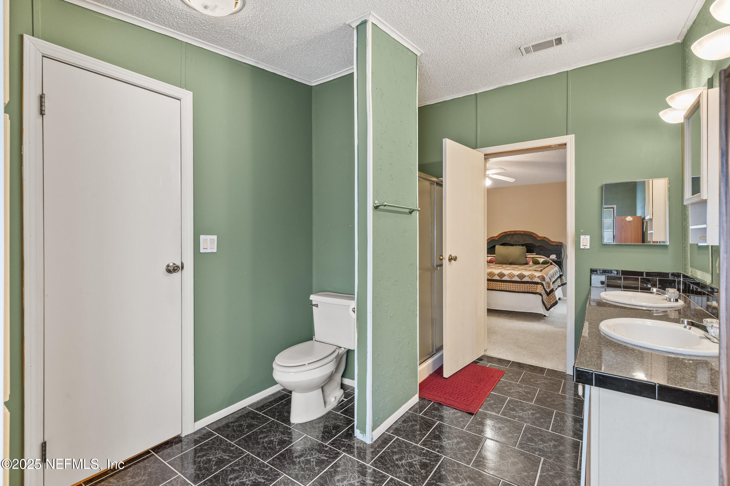5671 Chugah Street Keystone Heights, FL 32656 - Photo 30 of 47 a bathroom with a sink toilet and shower
