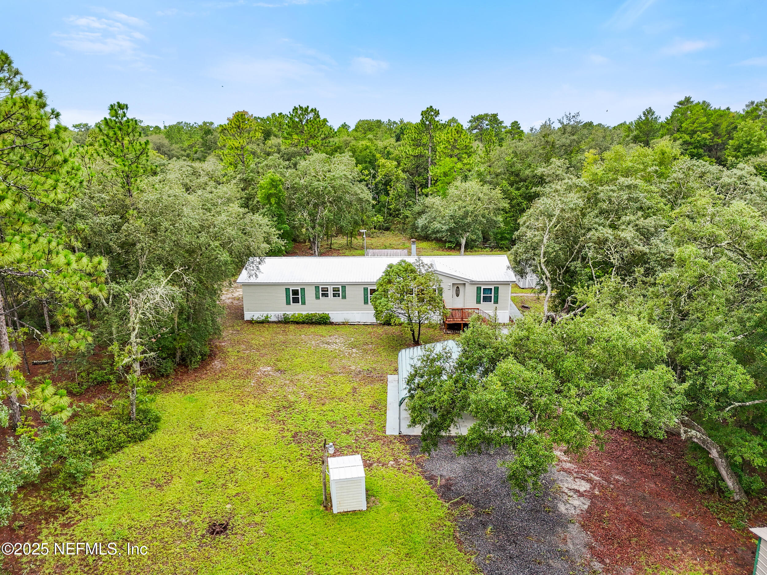 5671 Chugah Street Keystone Heights, FL 32656 - Photo 3 of 47 a view of a house with pool and trees in the background