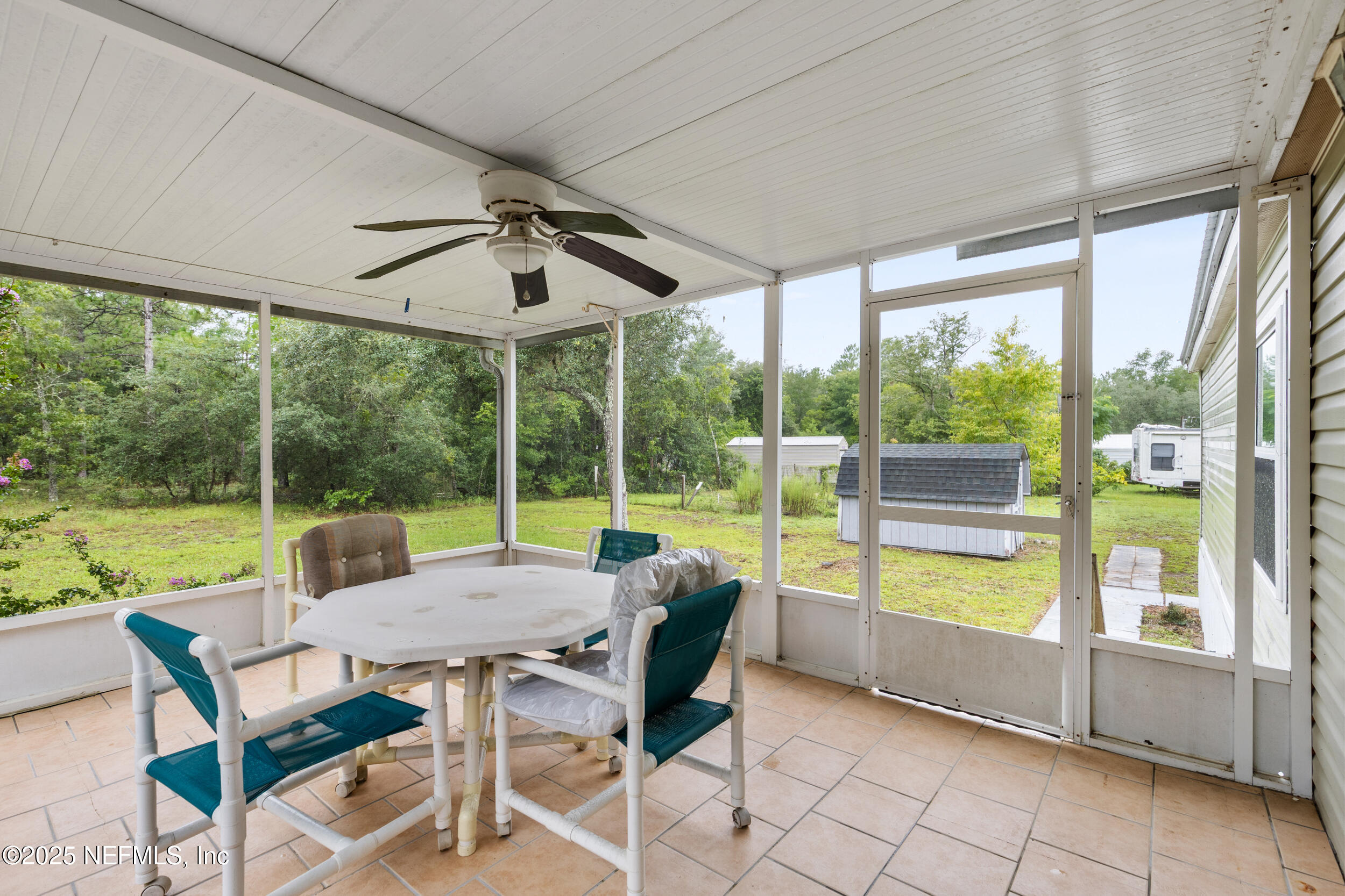 5671 Chugah Street Keystone Heights, FL 32656 - Photo 34 of 47 a view of a patio with a table chairs and a backyard