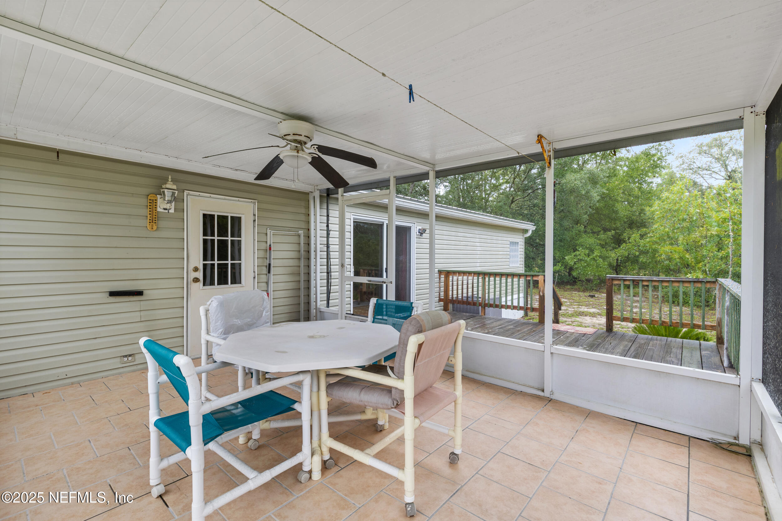 5671 Chugah Street Keystone Heights, FL 32656 - Photo 35 of 47 a view of a patio with a table and chairs