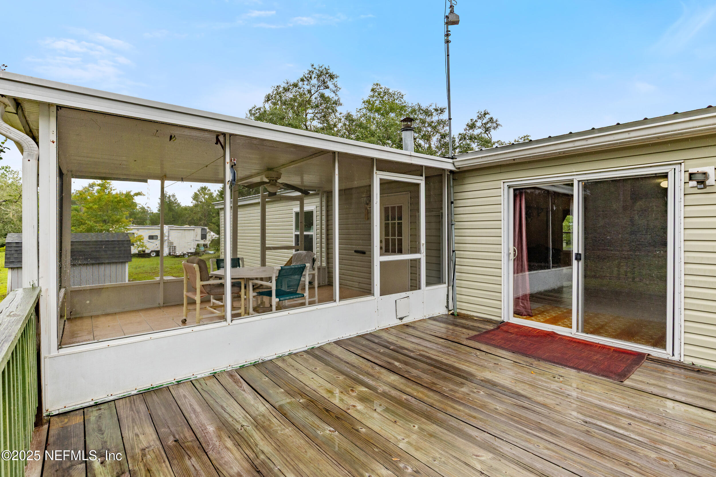 5671 Chugah Street Keystone Heights, FL 32656 - Photo 36 of 47 a view of a balcony with floor to ceiling windows with wooden floor