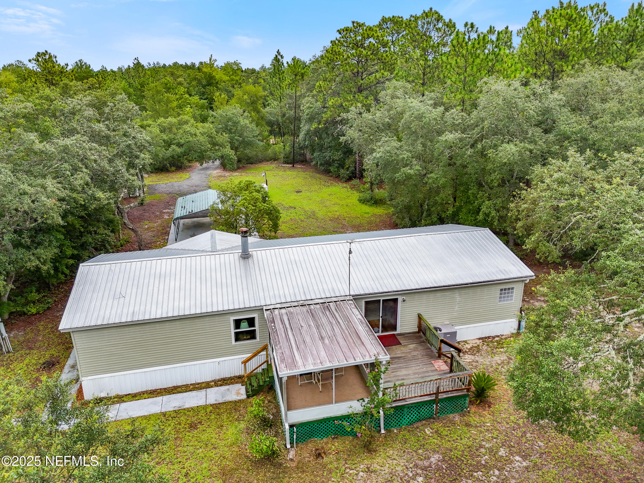 5671 Chugah Street Keystone Heights, FL 32656 - Photo 40 of 47 a view of a wooden deck and a backyard
