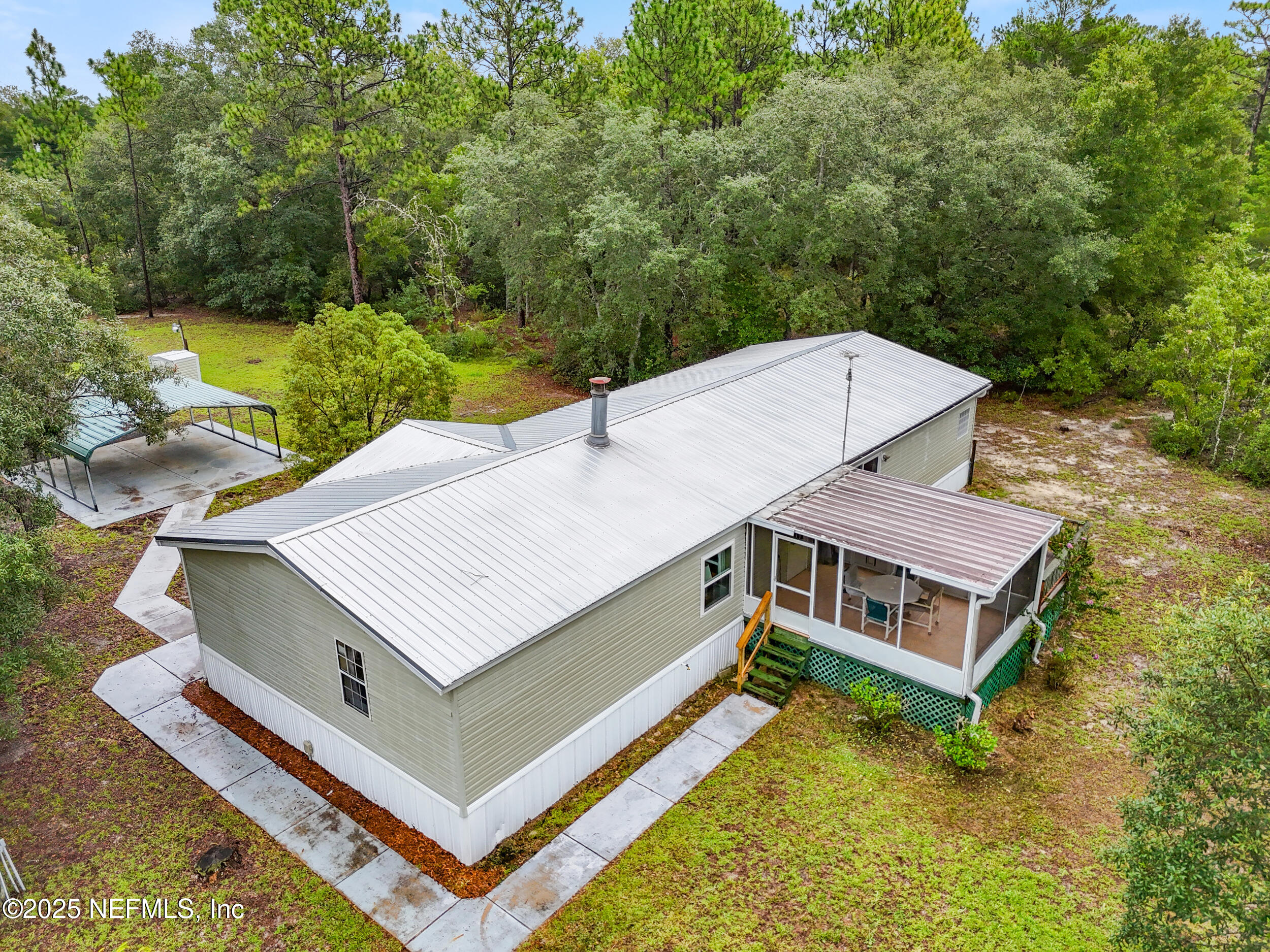 5671 Chugah Street Keystone Heights, FL 32656 - Photo 41 of 47 a view of a house with a big yard and large trees