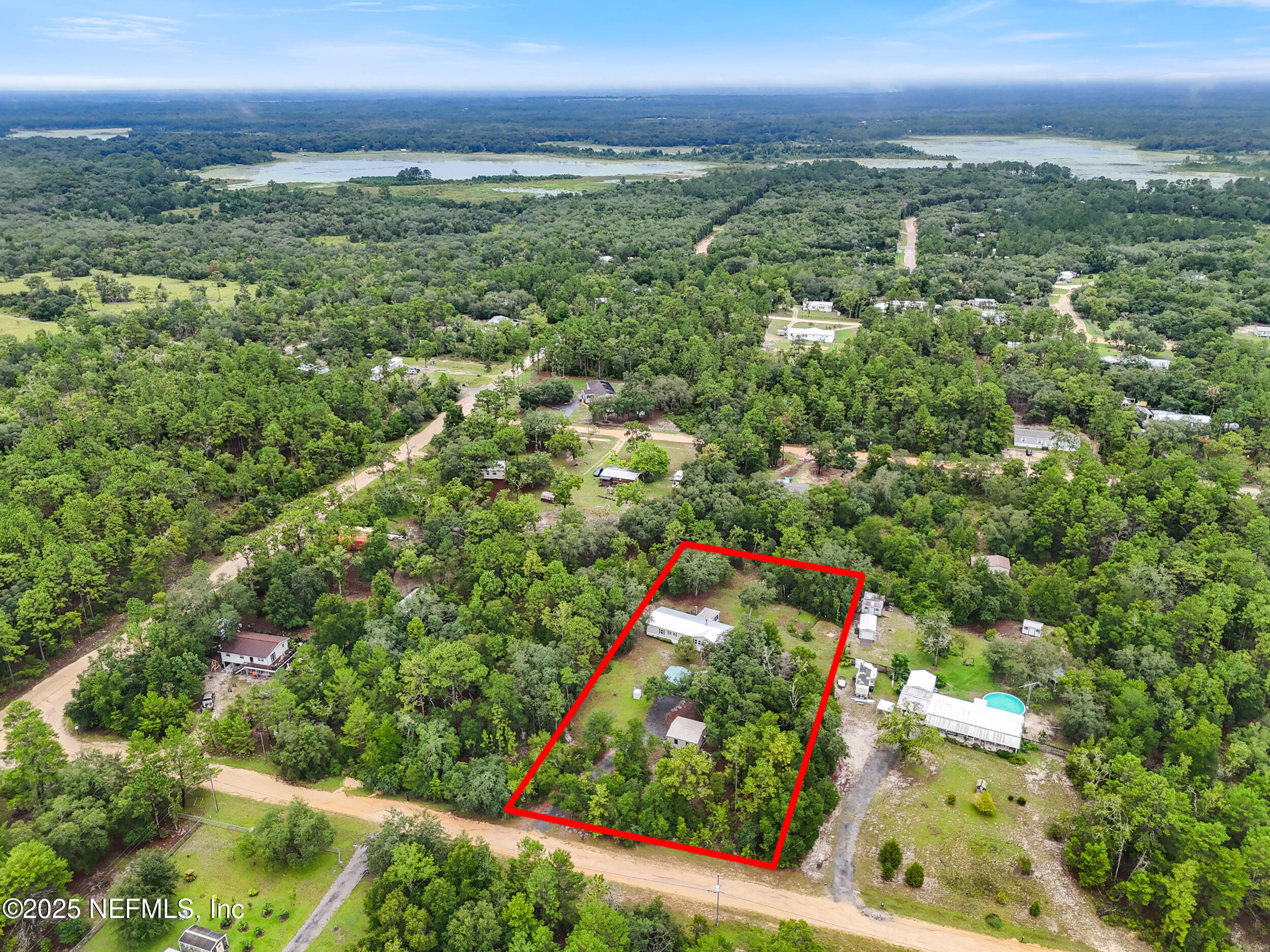 5671 Chugah Street Keystone Heights, FL 32656 - Photo 44 of 47 an aerial view of residential houses with outdoor space and trees