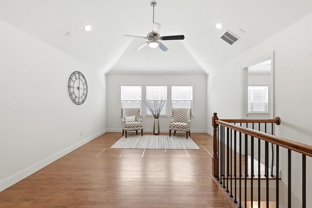 516 Sandy Lane Flower Mound, TX 75022 - Photo 22 of 38 Spacious loft area featuring a vaulted ceiling with a ceiling fan, recessed lighting, and wood-finish flooring