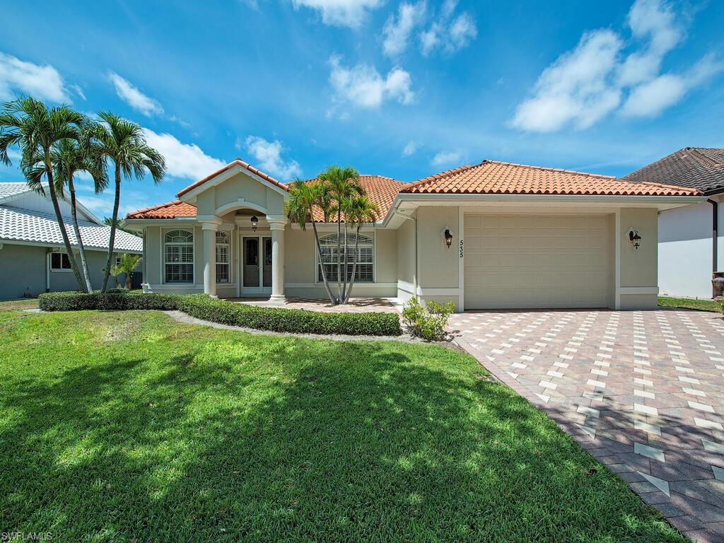 535 Roma Court Naples, FL 34110 - Photo 1 of 1 a front view of a house with a garden