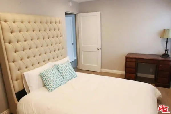 a bedroom with a bed and a dresser