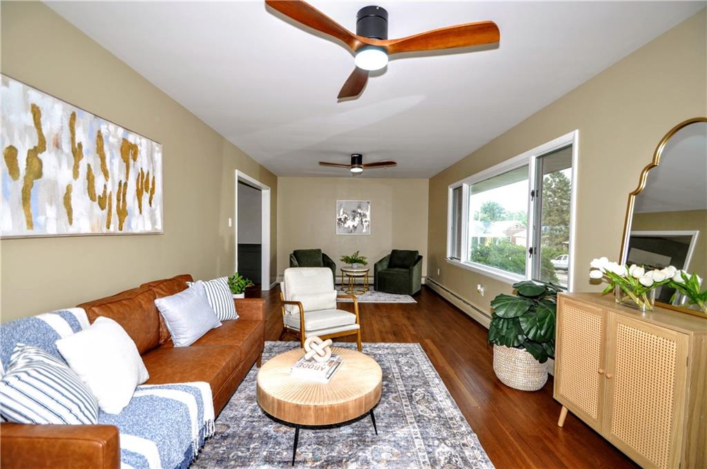 1168 Elm Street Monaca, PA 15061 - Photo 11 of 48 a living room with furniture potted plant and a large window