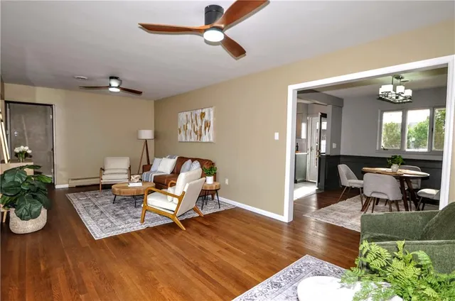 a living room with furniture and a wooden floor
