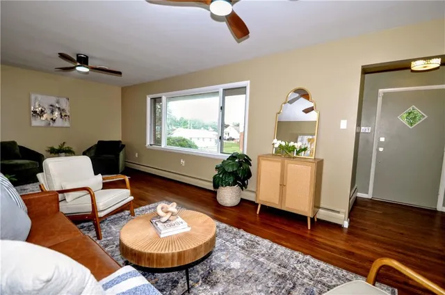 a living room with furniture and a wooden floor