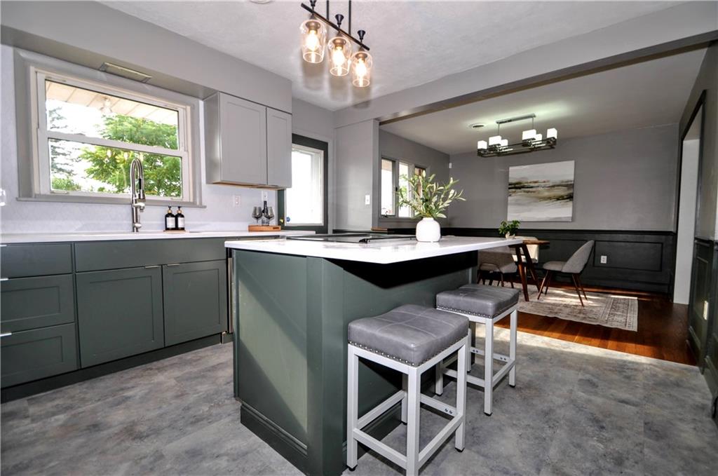 1168 Elm Street Monaca, PA 15061 - Photo 17 of 48 a kitchen with a table chairs sink and cabinets