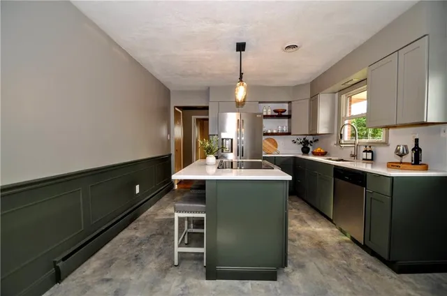 a kitchen with a sink appliances and cabinets