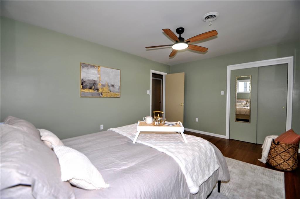1168 Elm Street Monaca, PA 15061 - Photo 22 of 48 a bedroom with a large bed and a chandelier