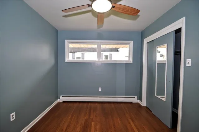 a view of room with window and wooden floor