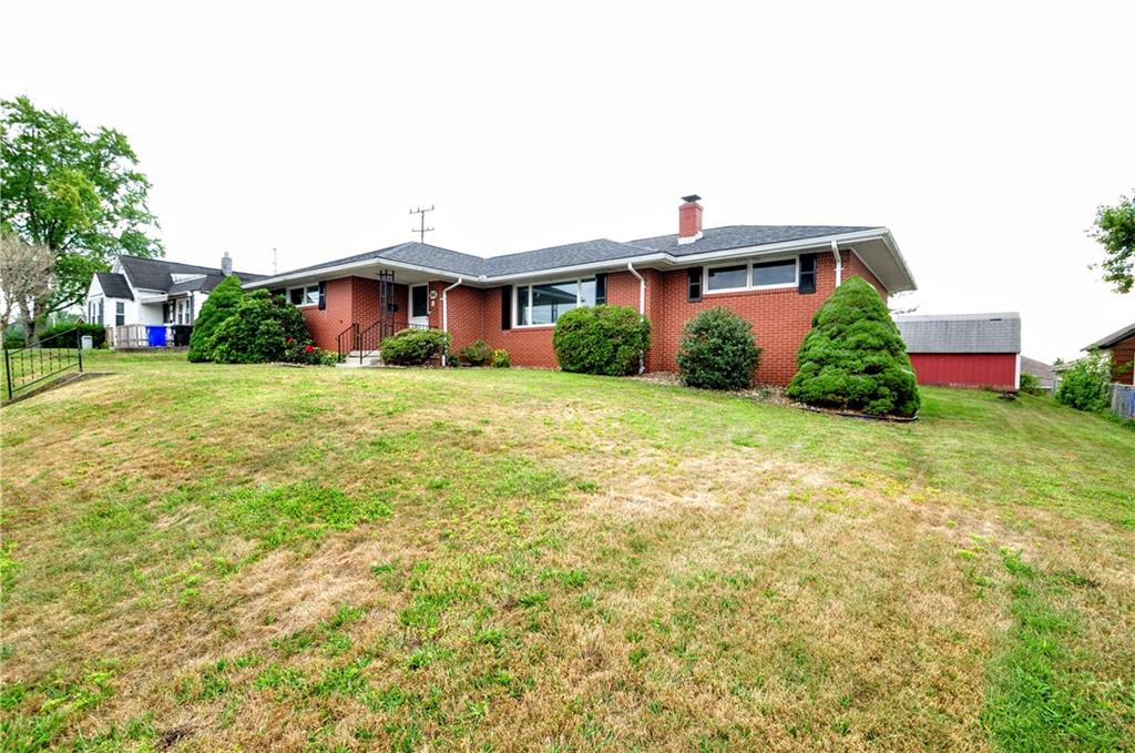 1168 Elm Street Monaca, PA 15061 - Photo 3 of 48 a front view of a house with a yard and garage