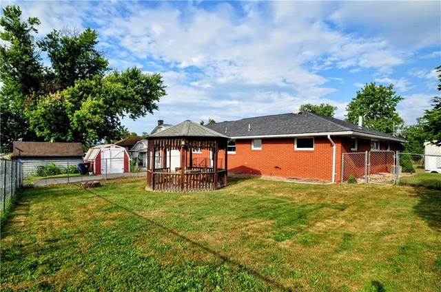 a view of a house with backyard and porch