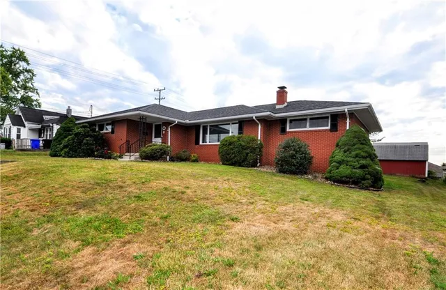 a front view of house with yard and green space