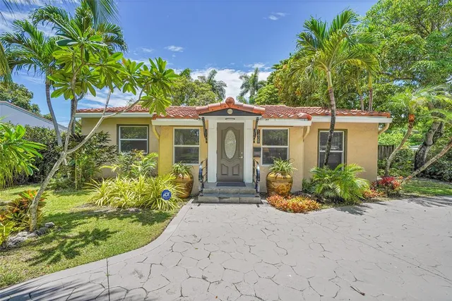 a front view of a house with a garden