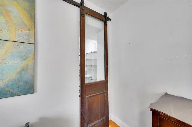 an aerial view of residential houses with outdoor space and trees