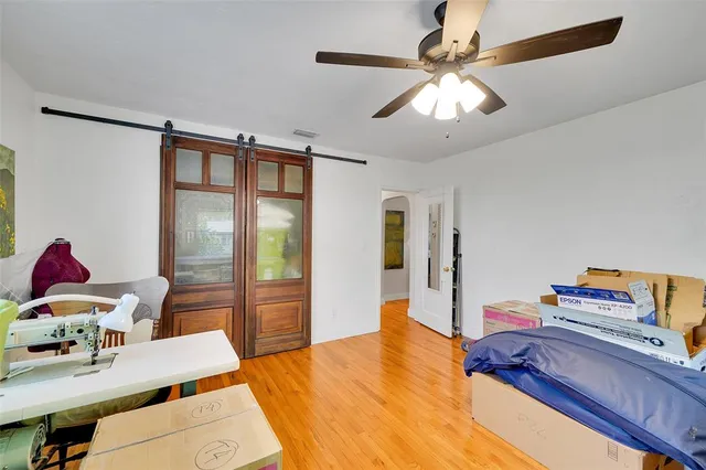 an aerial view of a residential houses with outdoor space and trees