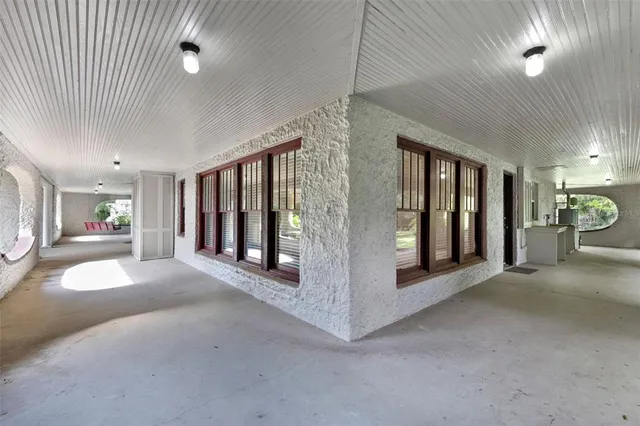 a view of a big room with closet and windows